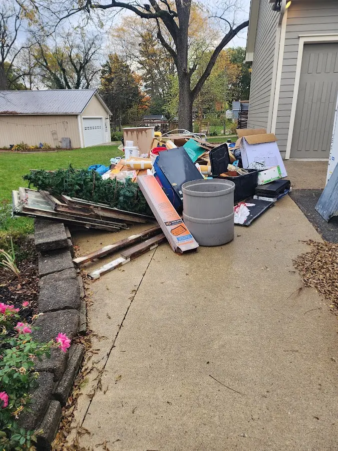 Dumpster being loaded with debris for Estate Cleanout Dumpster Rental in Sharonville